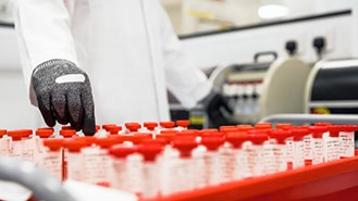 Test tüplerini yerleştiren siyah eldivenli bilim insanı 